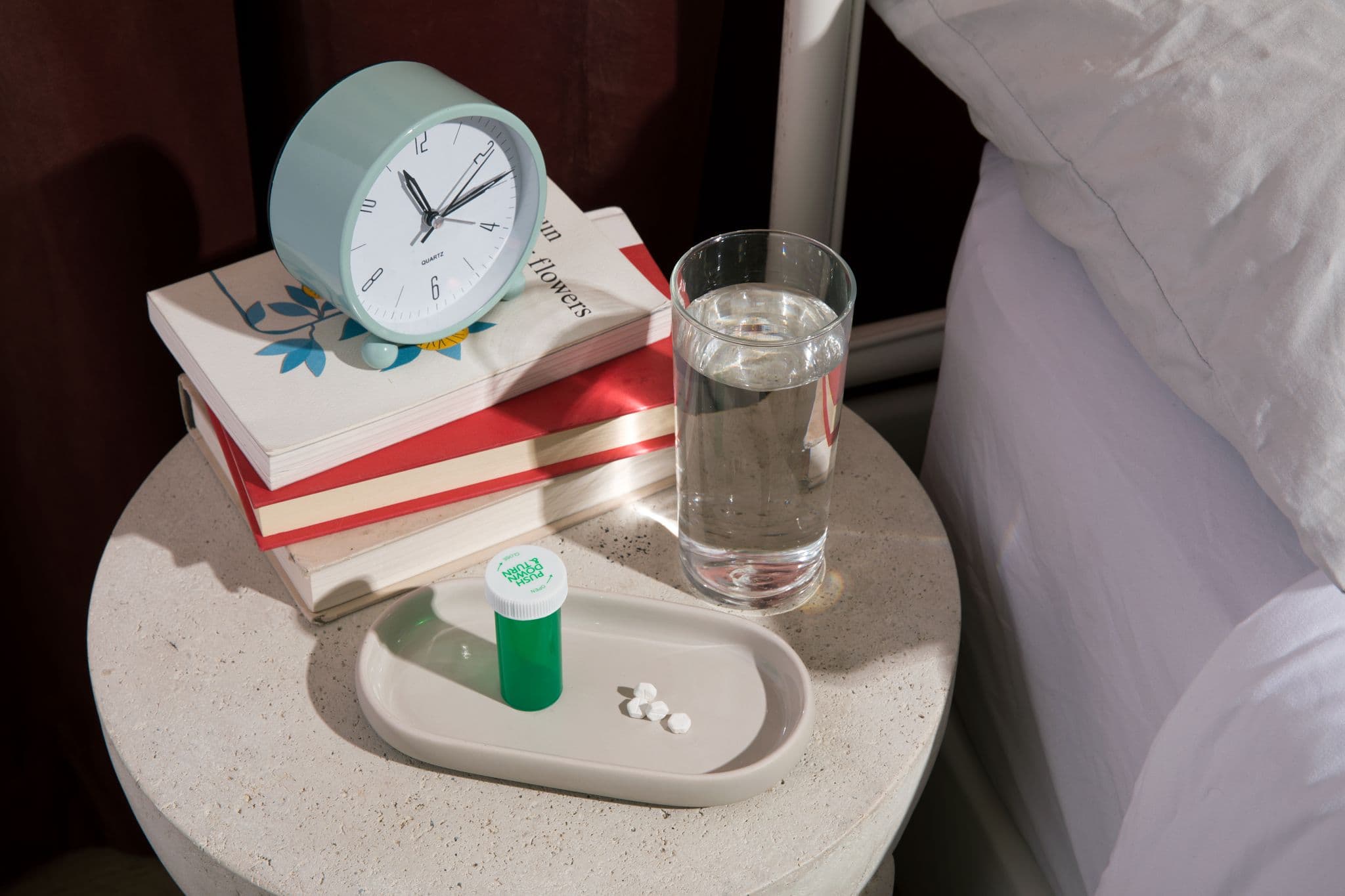Green pill bottle next to bed Green pill bottle next to bed